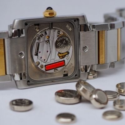 Disassembled Watch and Many Watch Batteries